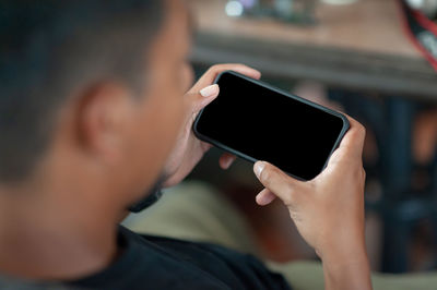 Midsection of man using mobile phone