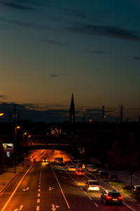 Traffic on road at sunset