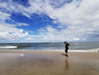 Full length of man on beach against sky