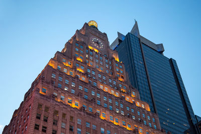 Low angle view of illuminated building against clear sky