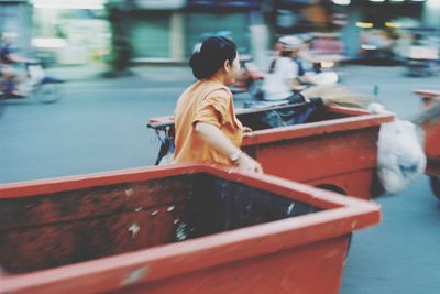 Rear view of man sitting on boat