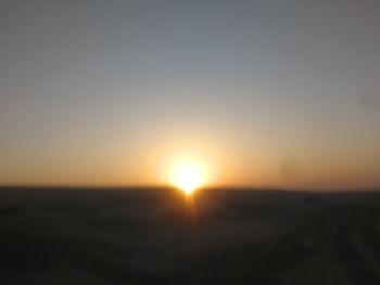 Scenic view of silhouette landscape against clear sky during sunset