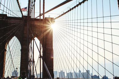 Low angle view of suspension bridge against sky