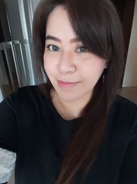 Portrait of smiling young woman at home