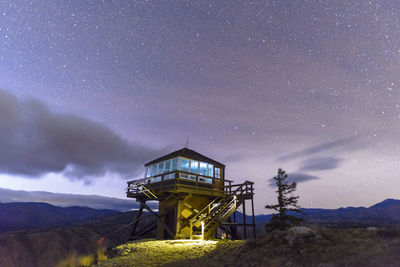 Fire lookout tower at night with stars