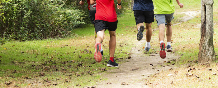 Low section of man running on field