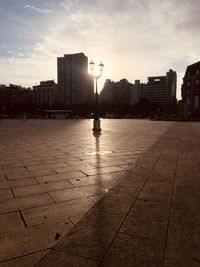 View of buildings at waterfront against cloudy sky