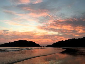 Scenic view of sea against romantic sky at sunset