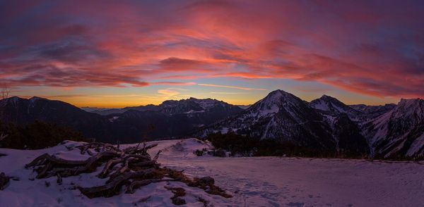 Scenic view of snowcapped mountains against sky during sunset