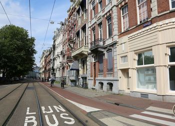 Road amidst buildings against sky