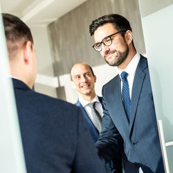 Businessmen shaking hands in office