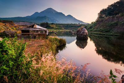 Scenic view of lake and buildings against sky