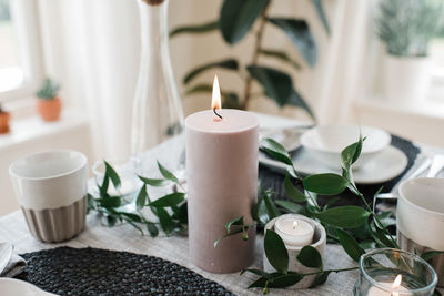 Large candle on a romantic dinner table for two