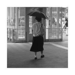 Woman standing on footbridge