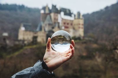 Person holding glass of building