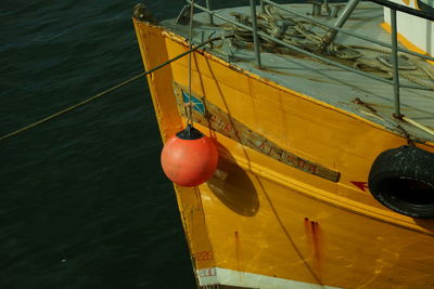 Close-up of yellow boat moored in sea