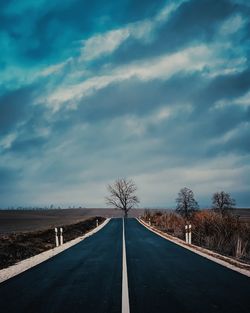 Empty straight road against sky