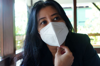 Portrait of a beautiful young woman with face mask