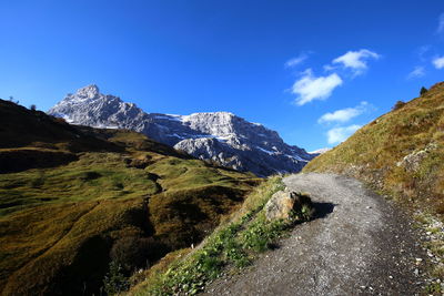 Low angle view of mountains against blue sky