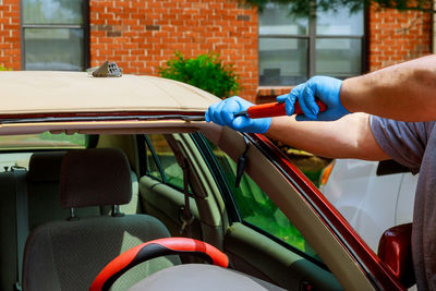 Cropped image of person repairing car