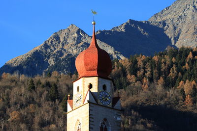 Low angle view of church by mountains