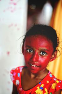 Portrait of girl during holi standing at home