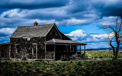 Houses against cloudy sky