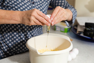 Midsection of woman preparing food in kitchen