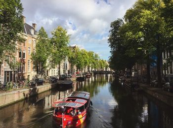 Boats in canal with buildings in background