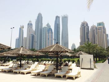 Buildings in city against clear sky