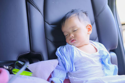 Cute boy sleeping in room