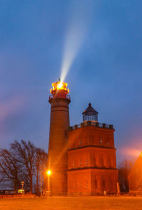 In rainy night shinning lighthouse cap arkona at the northern tip of german sea island of ruegen.