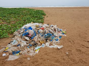 High angle view of garbage on sand at beach