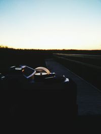 Close-up of car against sky during sunset
