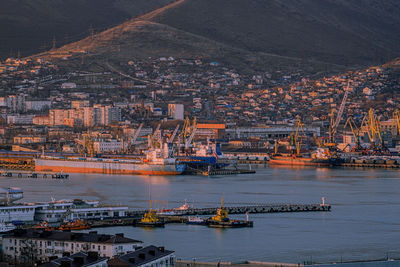 High angle view of city by sea against buildings