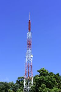 Low angle view of communications tower against clear blue sky