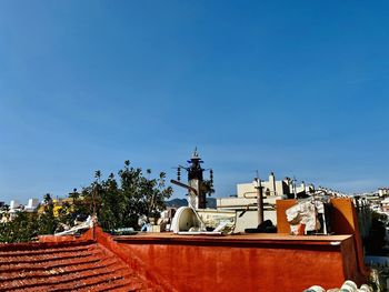 Panoramic view of buildings against blue sky