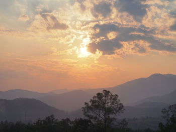 Scenic view of silhouette mountains against sky at sunset