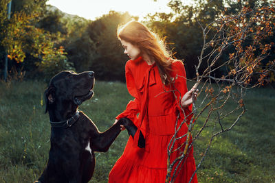 Young woman with dog on field