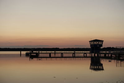 Silhouette pier on sea against sky during sunset