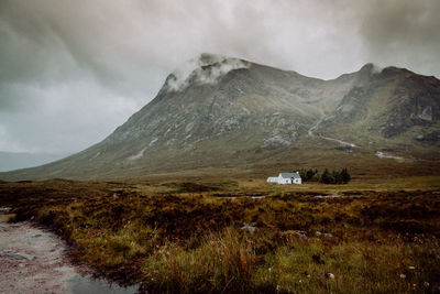 Scenic view of mountains against cloudy sky