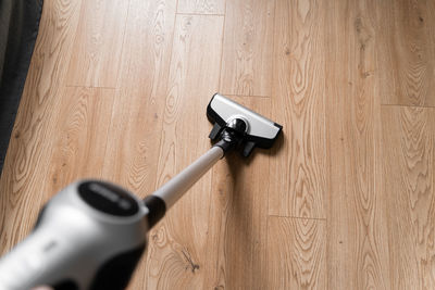 High angle view of vacuum cleaner cleaning floor