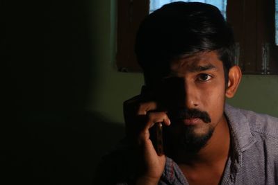 Portrait of young man talking on phone