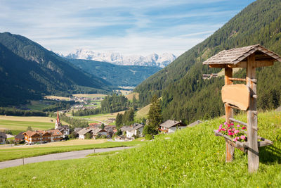 Scenic view of field and mountains against sky