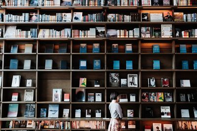 Full length of man reading book in library