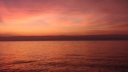 Scenic view of sea against orange sky