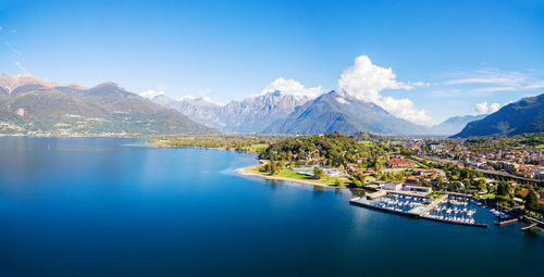 Scenic view of lake and mountains against blue sky