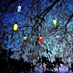 Low angle view of illuminated lanterns against sky at night