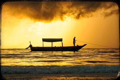 Scenic view of sea against cloudy sky at sunset