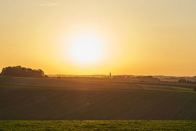 Scenic view of field against sky during sunset